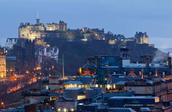 Panorama of Edinburgh Cityscape and castle from Calton Hill at dusk Scotland UK